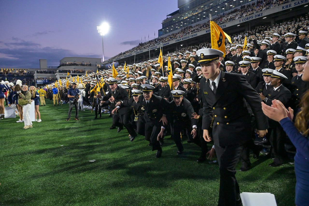 Midshipmen run on to the field to do pushups after Navy scores in the fourth quarter. The visiting North Texas Mean Green defeat the Navy Midshipmen, 49-39, in an NCAA football game Saturday at Navy-Marine Corps Memorial Stadium in Annapolis. (Paul W. Gillespie/Staff)