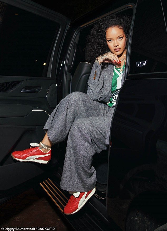 The 36-year-old mogul showed off her one-of-a-kind fashion sense as she layered a striped green and white soccer jersey underneath her double-breasted blazer, which had brown buttons