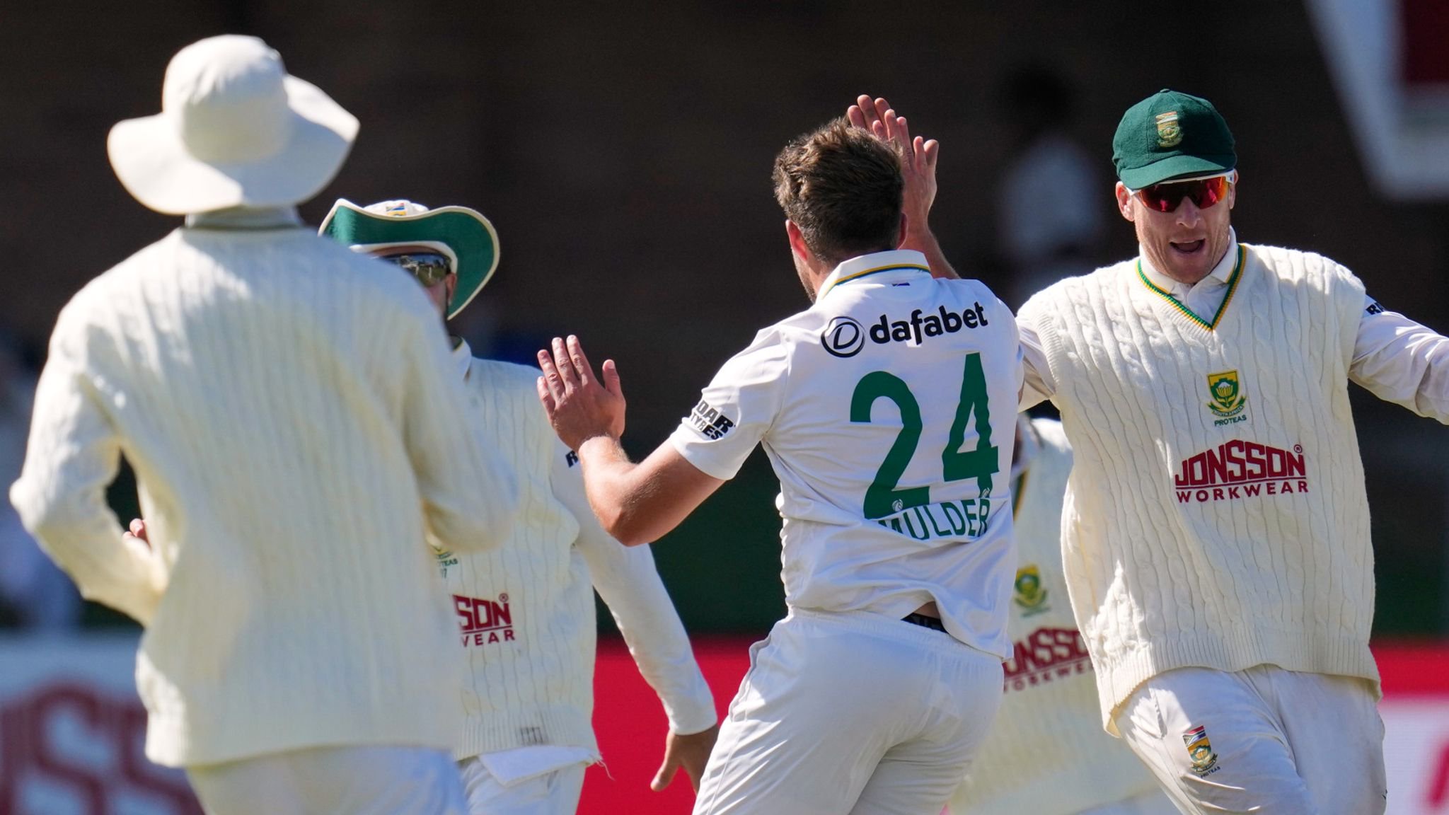 South Africa's Wiaan Mulder, centre, celebrates with team-mates after taking the wicket of Australia's Scott Boland 