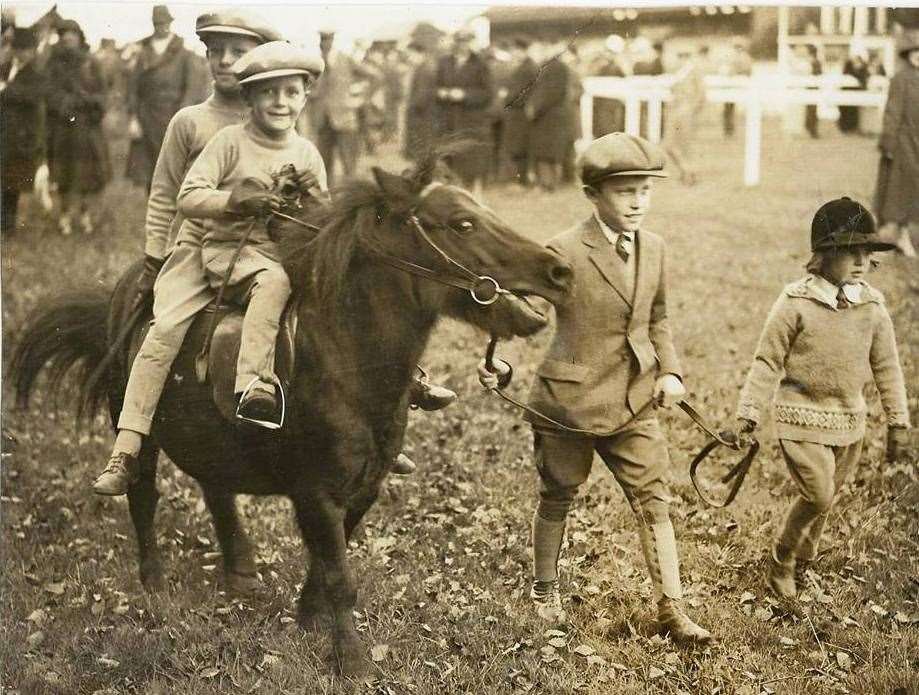 Bill and Fred Rickaby on their pony being led by George Archibald and Pamela Griggs