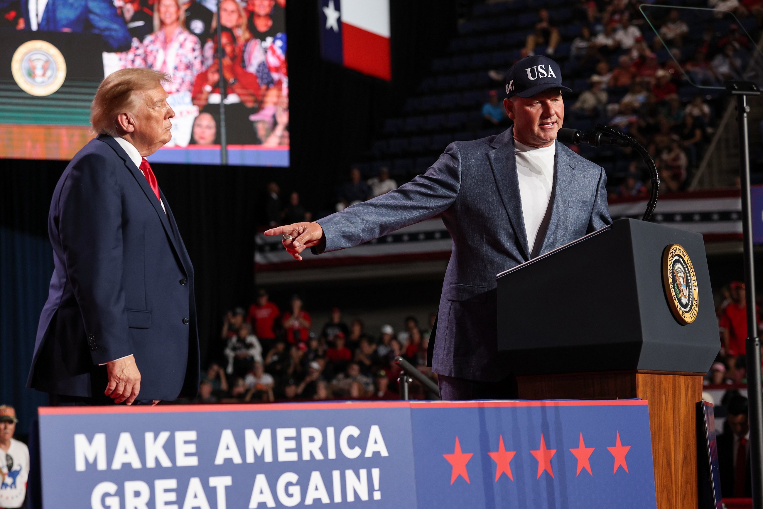 SAN ANTONIO, TEXAS - OCTOBER 07: U.S. President Donald Trump (L) listens as former MLB player Roger Clemens speaks on stage during a campaign rally at the Freeman Coliseum on October 07, 2026 in San Antonio, Texas. On his third trip to the state in the last 30 days, Trump is visiting Texas to campaign for Republican candidates, including Senate candidate and Texas Attorney General Ken Paxton, ahead of the midterm elections. (Photo by Win McNamee/Getty Images)
