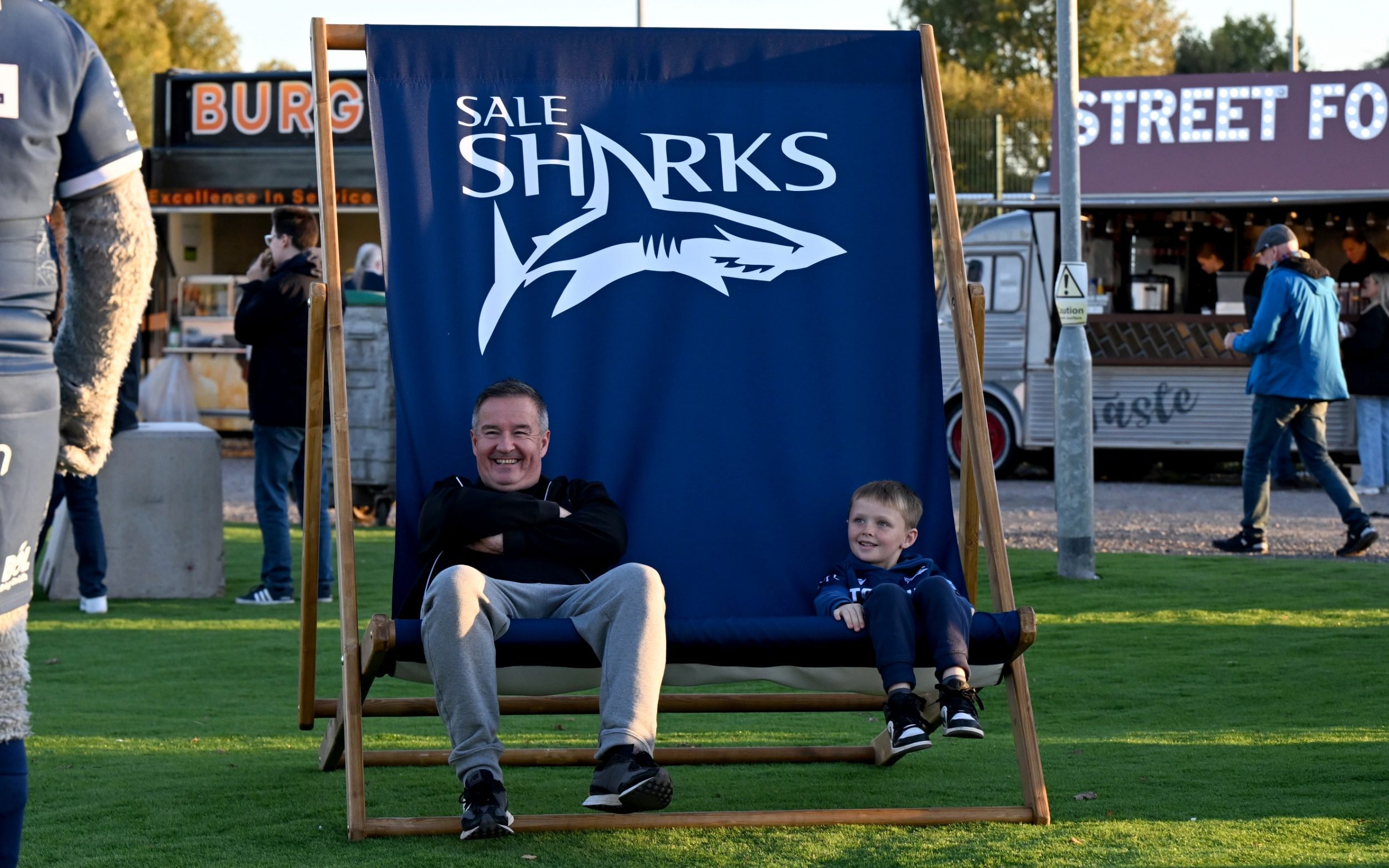 Fans sit in a giant deck chair outside the ground