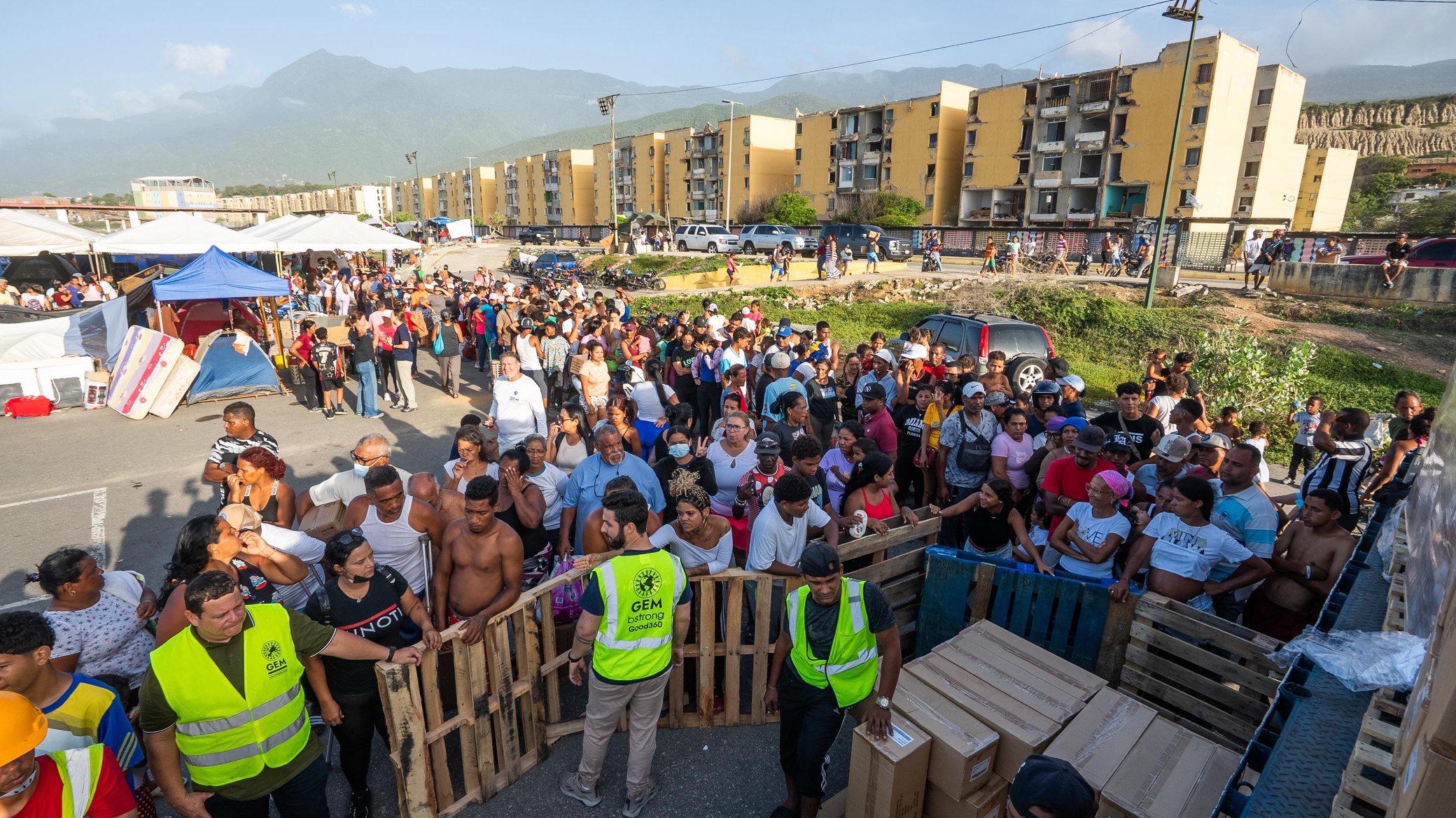 Venezuelans line up to receive donations collected in Milwaukee and across the U.S. in the wake of two devasting earthquakes to strike the country.