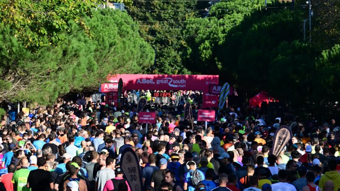 A crowd gathered, wearing running kit, at the Great South Run on a pleasant, sunny day. 