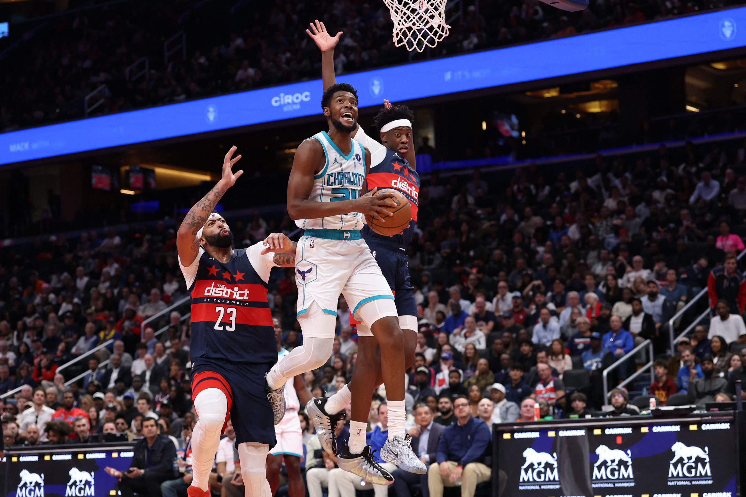 Oct 30, 2026; Washington, District of Columbia, USA; Charlotte Hornets forward Brandon Miller (24) is fouled by Washington Wizards forward AJ Dybantsa (4) while attempting a shot as Wizards forward Anthony Davis (23) defends in the first half in an NBA Cup game at Capital One Arena. Mandatory Credit: Geoff Burke-Imagn Images