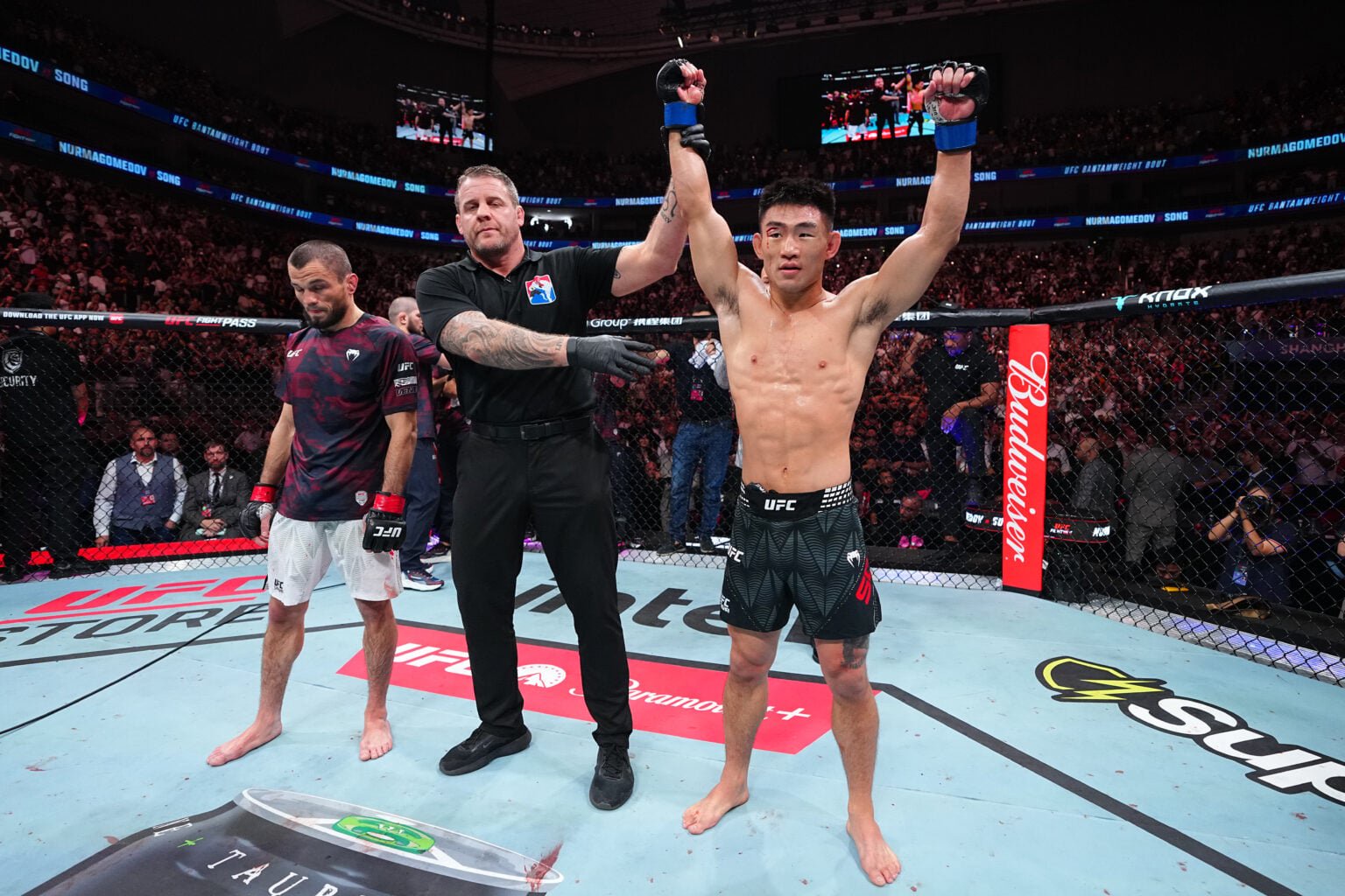 Song Yadong has his hand raised after knocking out Umar Nurmagomedov in their fight at UFC Shanghai