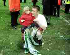 Tommy Johnson of Celtic celebrates with his daughter after winning the Bank of Scotland Premier League Championship at Celtic Park, Glasgow. Mandat...