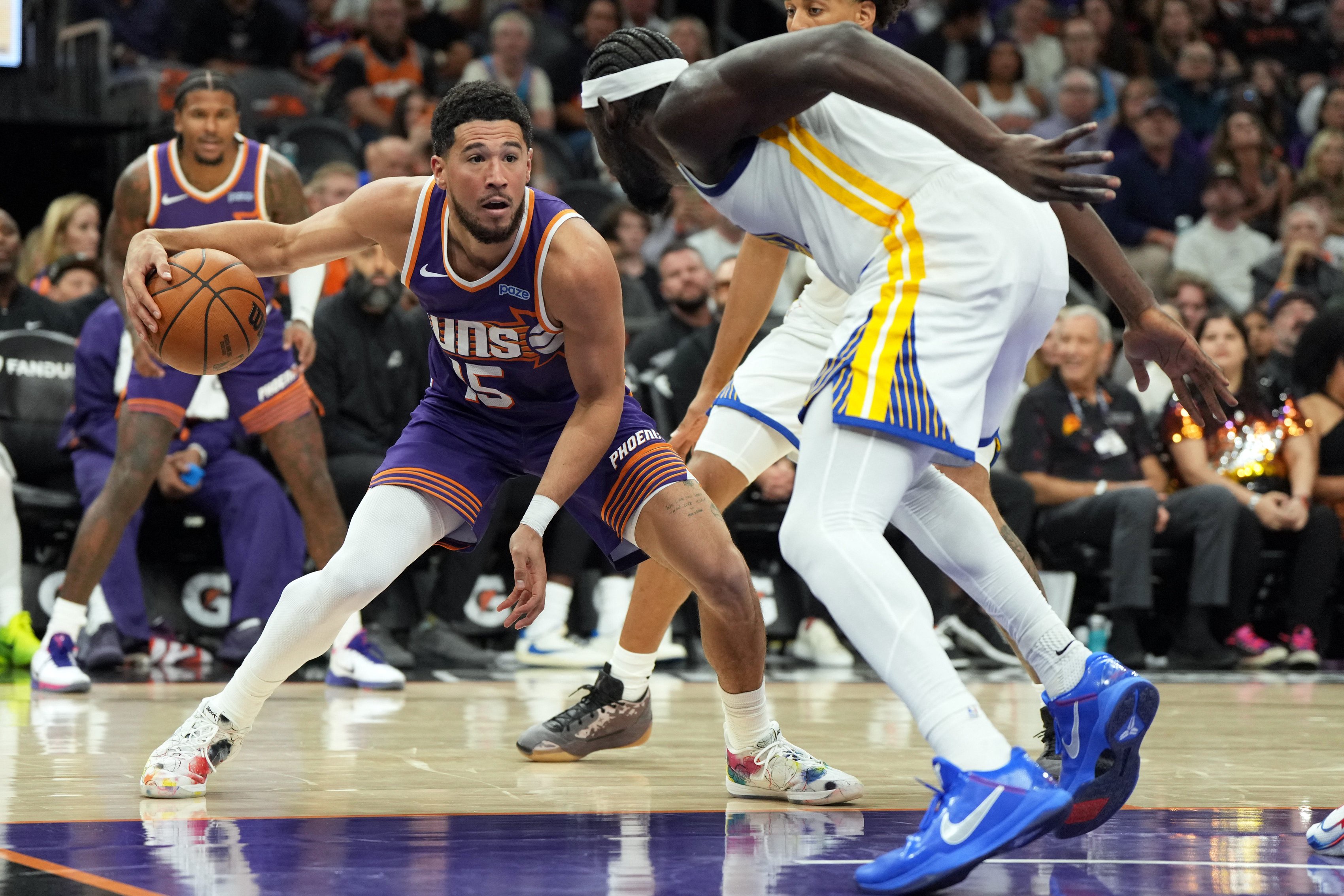 Oct 24, 2026; Phoenix, Arizona, USA;  Phoenix Suns guard Devin Booker (15) drives against the Golden State Warriors in the second half at Mortgage Matchup Center.  Mandatory Credit: Rick Scuteri-Imagn Images