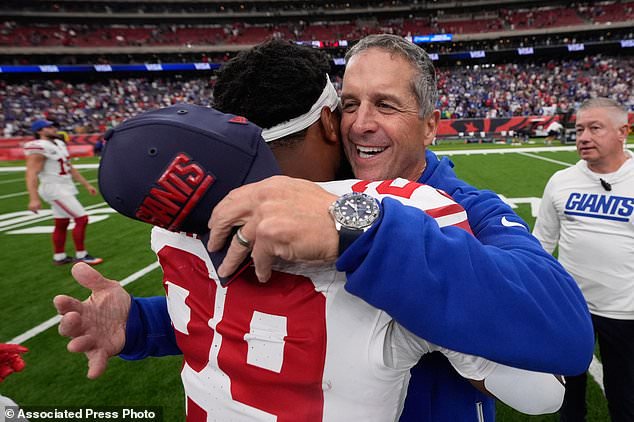 New York Giants head coach John Harbaugh, front right, celebrates with Tyrone Tracy Jr., left, after an overtime win over the Houston Texans in an NFL football game in Houston, Sunday, Oct. 25, 2026. (AP Photo/Gerald Herbert)