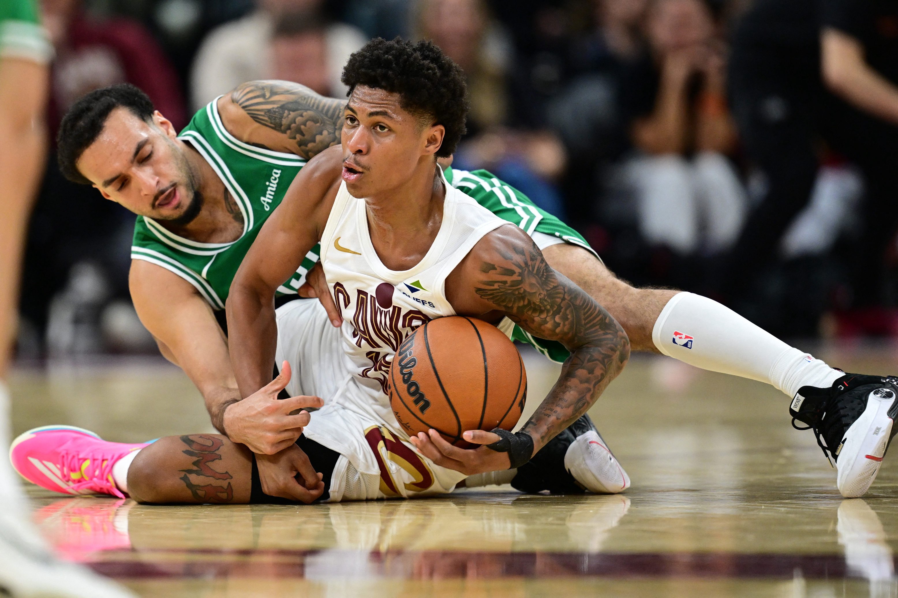 Oct 8, 2026; Cleveland, Ohio, USA;  Cleveland Cavaliers guard Meleek Thomas (15) protects the ball from Boston Celtics guard Devin Carter (99) during the second half of a preseason game at Rocket Arena.  Mandatory Credit: David Dermer-Imagn Images