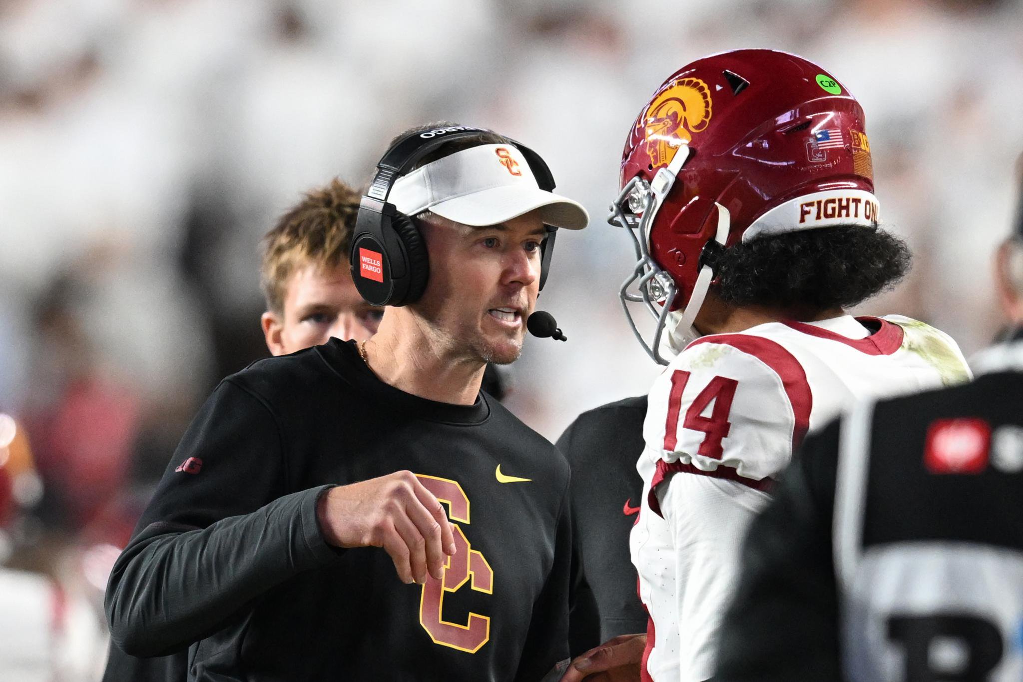 USC football coach Lincoln Riley talks to a player during a game against Penn State.