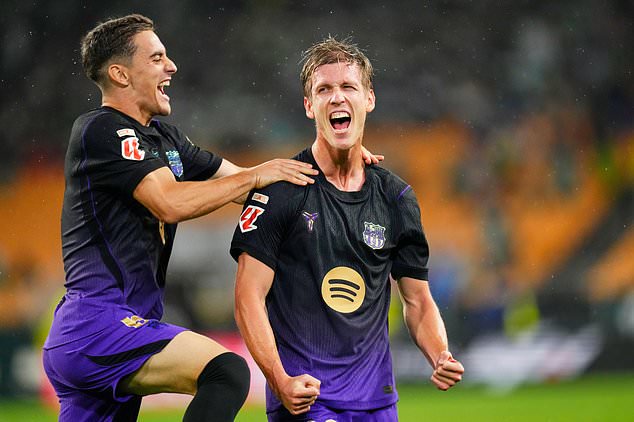 Barcelona's Dani Olmo, right, celebrates after scoring during the Spanish La Liga soccer match between Real Betis and Barcelona in Seville, Spain, Saturday, Oct. 17, 2026. (AP Photo/Jose Breton)