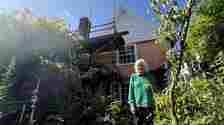 Gill Hayes-Newington pictured in front of her neighbour's scaffold in her garden