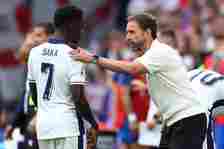 England Manager Gareth Southgate speaks to Bukayo Saka of England during the UEFA EURO 2024 round of 16 match between England and Slovakia at Arena...