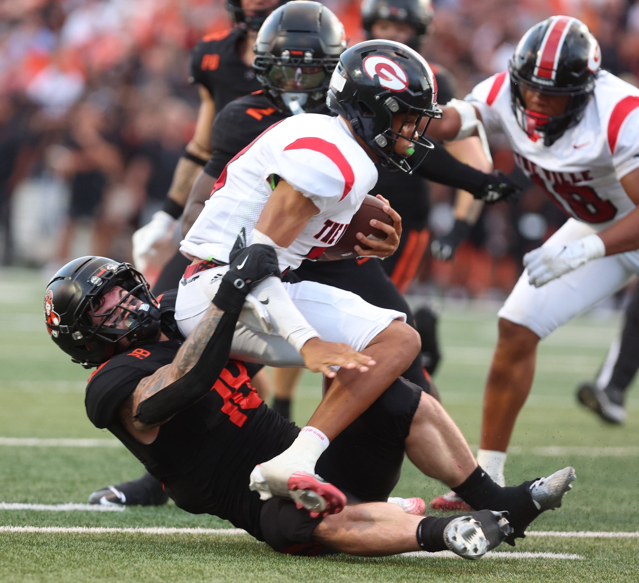 Massillon’s Brayton Feister sacks Glenville quarterback LaMarques Greenwood in the first half at Paul Brown Tiger Stadium. Friday, Aug. 21, 2026.