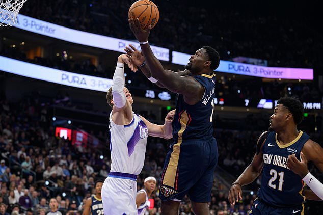 New Orleans Pelicans forward Zion Williamson, center, looks to shoot over Utah Jazz forward Lauri Markkanen, left, during an NBA basketball game, Friday, Oct. 23, 2026, in Salt Lake City. (AP Photo/Tyler Tate)