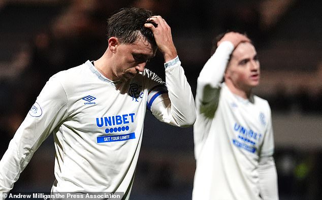 Dan Neil, above left, is crestfallen after his gaffe allowed Dundee to make it 2-2