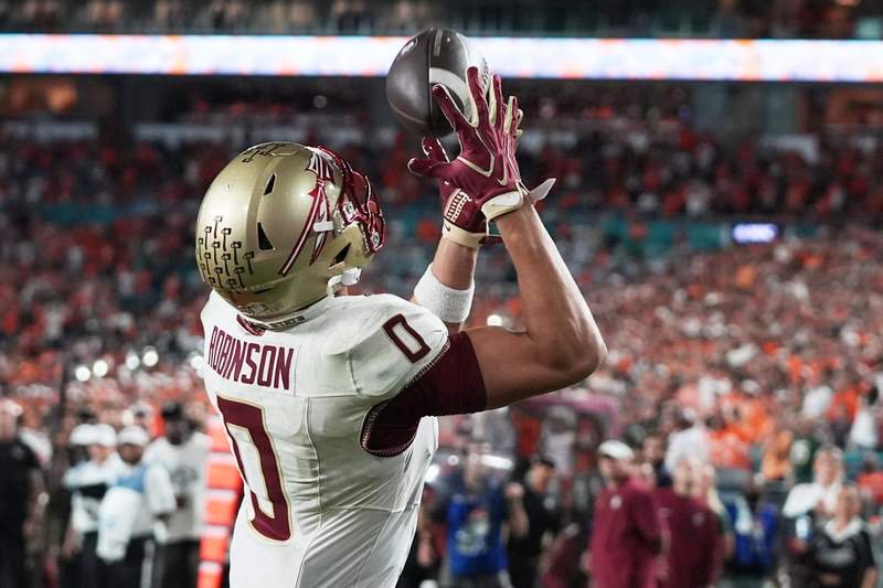 Florida State wide receiver Duce Robinson scores a touchdown during the first overtime.
