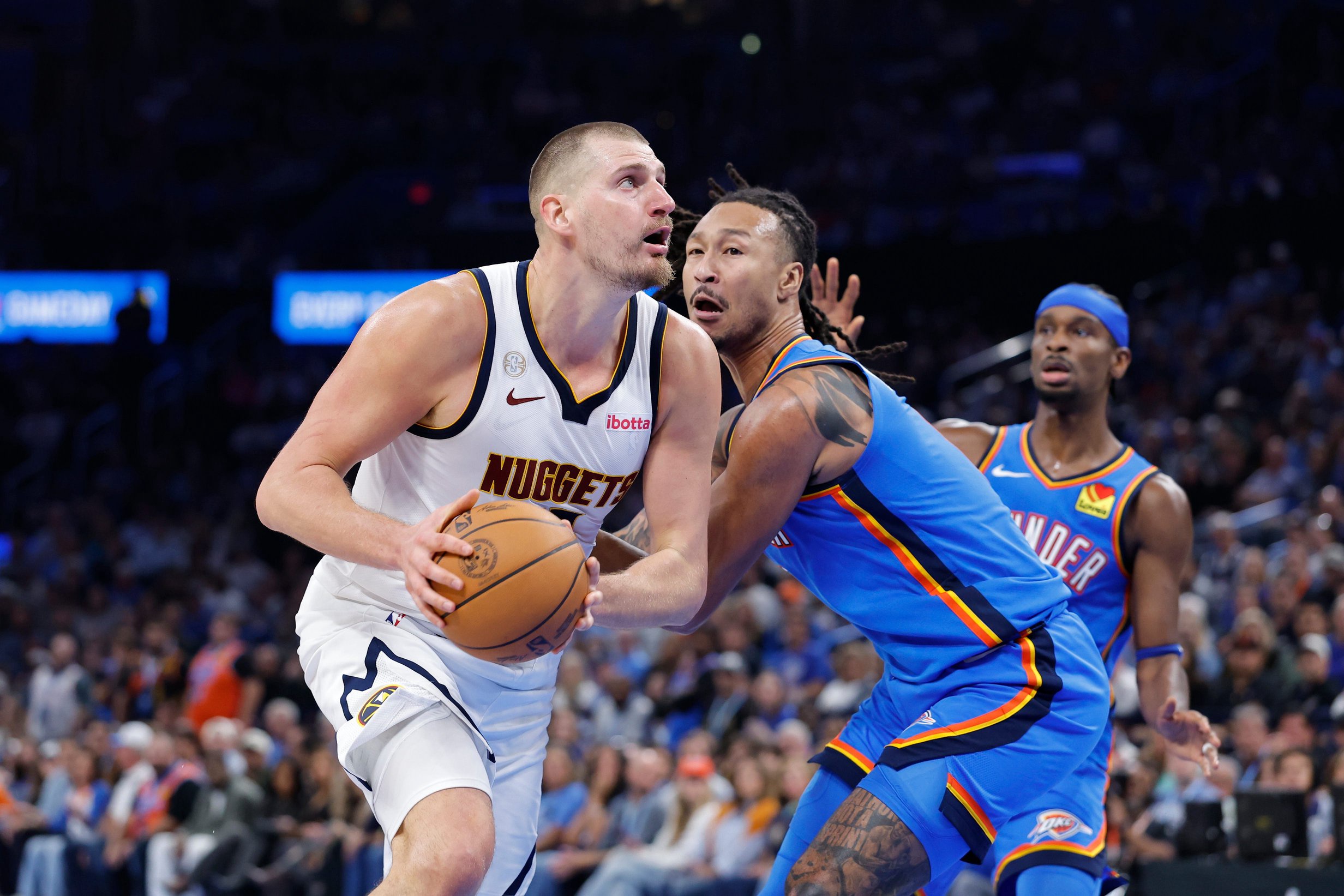 Oct 22, 2026; Oklahoma City, Oklahoma, USA; Denver Nuggets center Nikola Jokic (15) drives past Oklahoma City Thunder forward Jaylin Williams (6) during the second half at Paycom Center. Mandatory Credit: Alonzo Adams-Imagn Images