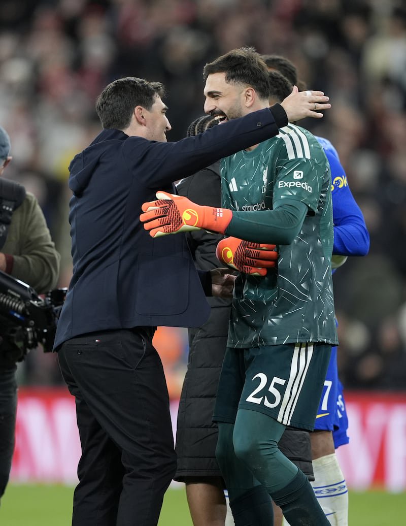 Liverpool manager Andoni Iraola (left) hugs goalkeeper Giorgi Mamardashvili after the penalty shoot-out