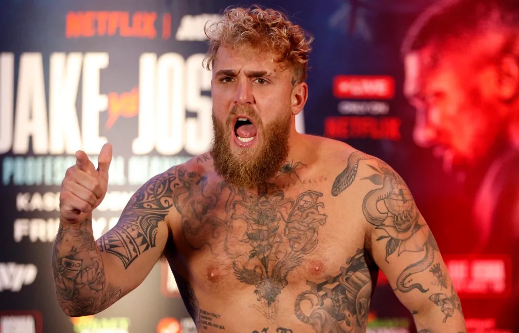 Jake Paul yells and points at the camera during a weigh-in.