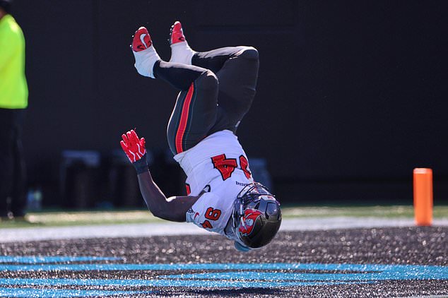 Tampa Bay Buccaneers defensive tackle Calijah Kancey (94) returns a fumble for a touchdown during the first half of an NFL football game against the Carolina Panthers in Charlotte, N.C., Sunday, Oct. 25, 2026. (AP Photo/Scott Kinser)