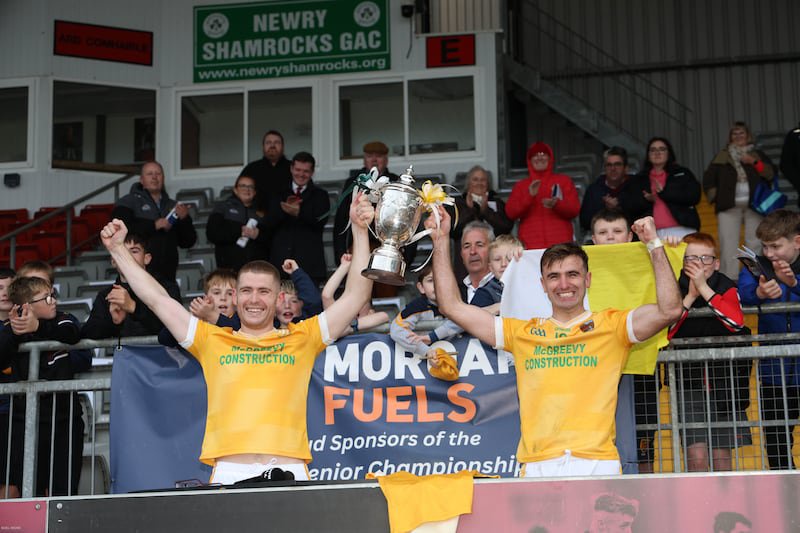 Charlie Carr and Stephen McConville lift the Frank O'Hare Cup after beating Burren in the Down Senior Championship Final on Sunday.