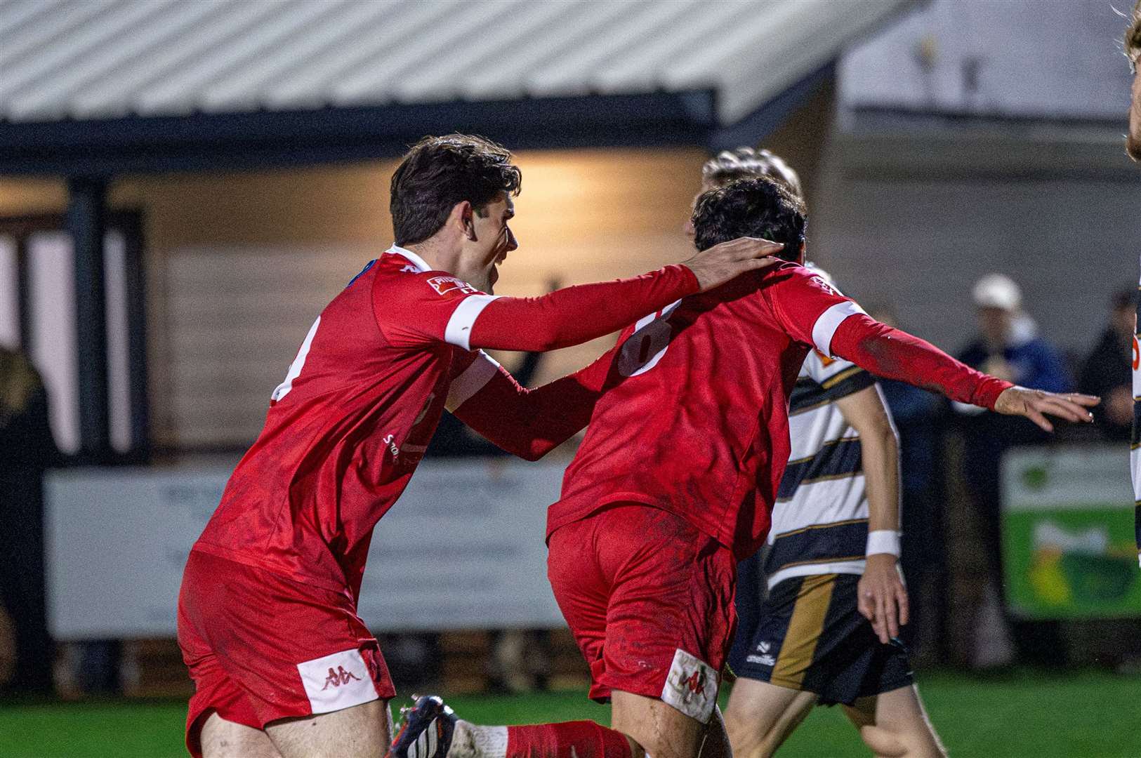 Faversham midfielder Jack Evans wheels away to celebrate his early opener with team-mate Josh Strouts at the Charles Sports Ground. Picture: Nathan Munday