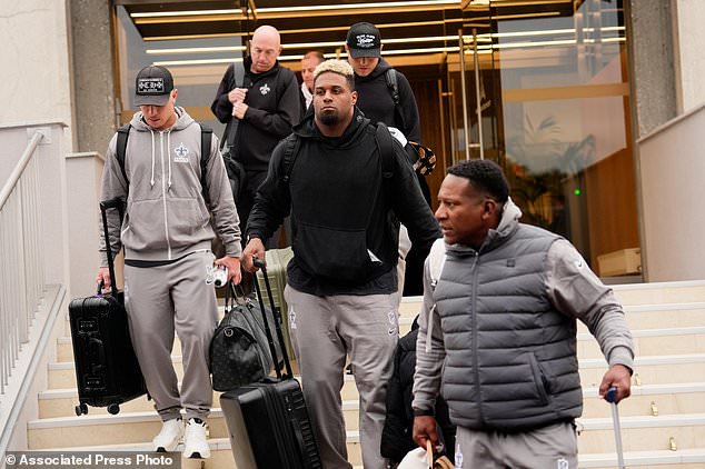 New Orleans Saints' Cameron Jordan, center, arrives at the reception pavilion of Charles de Gaulle airport in Roissy north of Paris, Monday, Oct. 19, 2026. (AP Photo/Teresa Suarez)