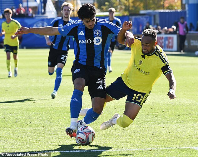 Nashville SC's Sam Surridge, left, and CF Montreal's Hennadii Synchuk battle for the ball during the first half of an MLS soccer game in Montreal, Saturday, Oct. 24, 2026. (Graham Hughes/The Canadian Press via AP)