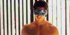 Christian Bale's Patrick Bateman with tanning goggles on in the tanning booth, half naked in American Psycho