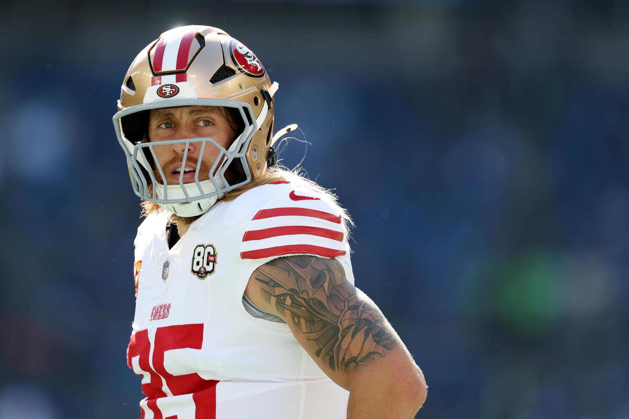 George Kittle #85 of the San Francisco 49ers looks on before a game against the Seattle Seahawks at Lumen Field in Seattle, Washington, on October 11, 2026.