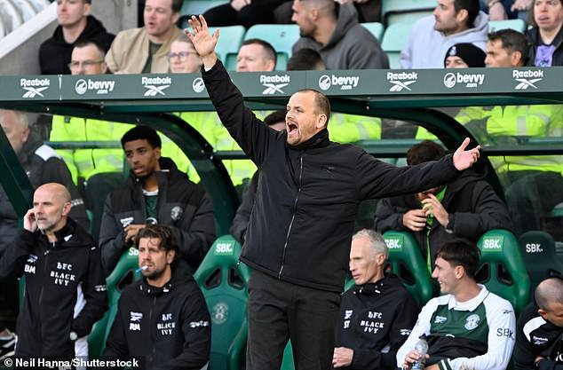 Hibernian manager Marink Reedijk urges his players on from the sidelines
