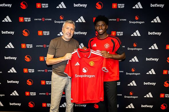Carlos Baleba poses for a picture with Jason Wilcox after signing for Manchester United