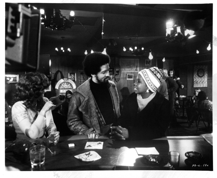Bobbie Shaw Chance, Barry Hankerson, and Gladys Knight at a bar in a scene from the film "Pipe Dreams," in 1976. | Source: Getty Images