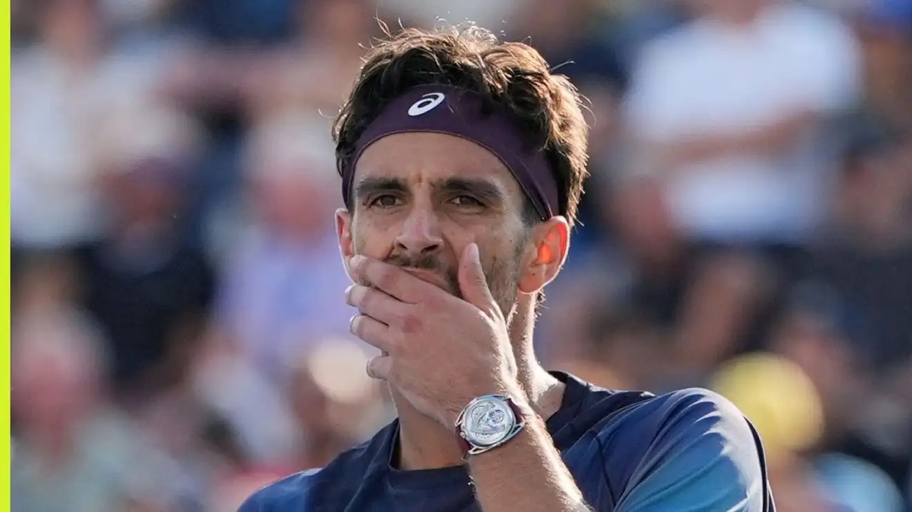 Pictured: Lorenzo Musetti puts his hand to his face