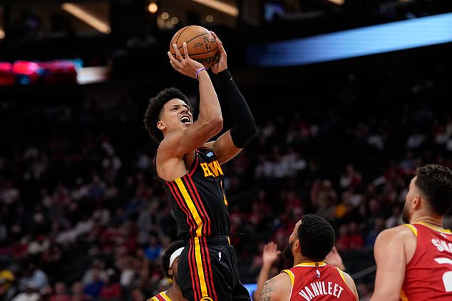 Atlanta Hawks forward Jalen Johnson, top, goes up to shoot during the first quarter of an NBA basketball game against the Houston Rockets, Monday, Oct. 26, 2026, in Houston. (AP Photo/Kevin M. Cox)