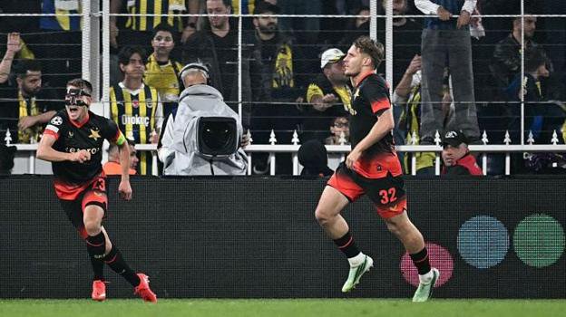Pavel Kacor celebrates the late equaliser for Slavia Prague with masked team-mate Michal Sadilek