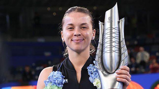 Maja Chwalinska smiles as she holds the silver-coloured Wuhan Open trophy