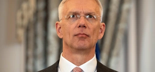 Latvia's foreign minister will step down after a probe over his office's use of private flights