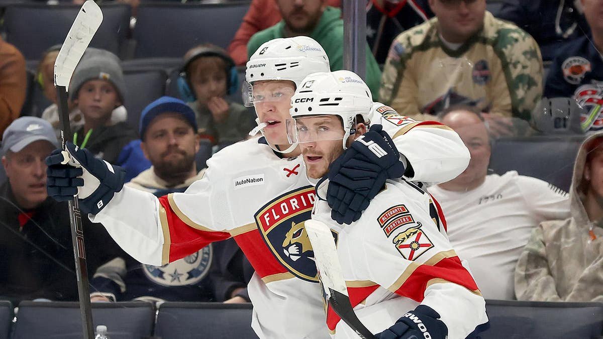 Brady Tkachuk is congratulated by his brother Matthew Tkachuk after scoring a goal.