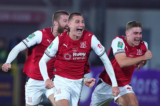 Fleetwood's players celebrate after winning a penalty shootout during the English League Cup soccer match between Fleetwood Town and Arsenal in Fleetwood, England, Tuesday, Oct. 27, 2026. (AP Photo/Ian Hodgson)