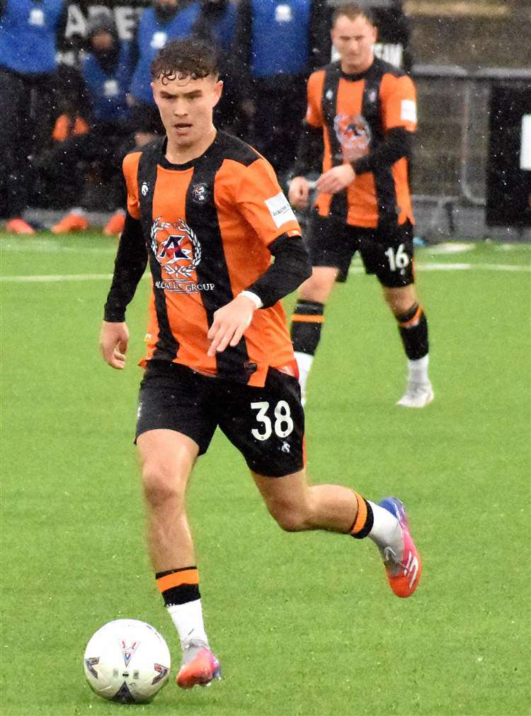 First-half scorer Harvey Kedwell in possession for Folkestone as team-mate Adam Lovatt watches on from the rain in the background in a 2-0 National League South success over Farnborough on Saturday. Picture: Randolph File
