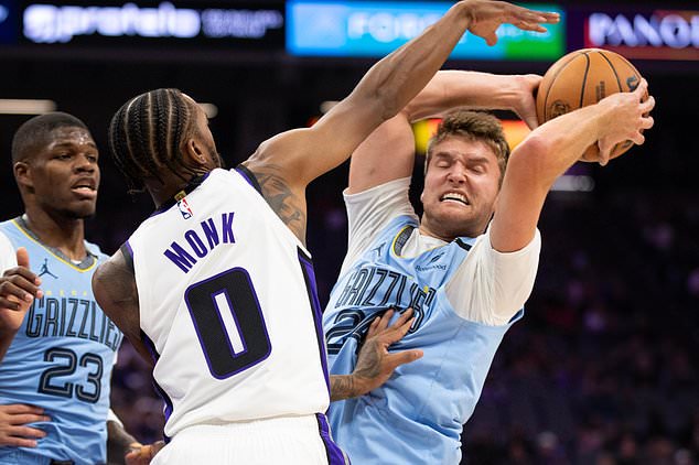 Sacramento Kings guard Malik Monk (0) defends Memphis Grizzlies guard Cam Spencer (24), right, during the first half of an NBA basketball game, Sunday, Oct. 25, 2026, in Sacramento, Calif. (AP Photo/Jose Luis Villegas)