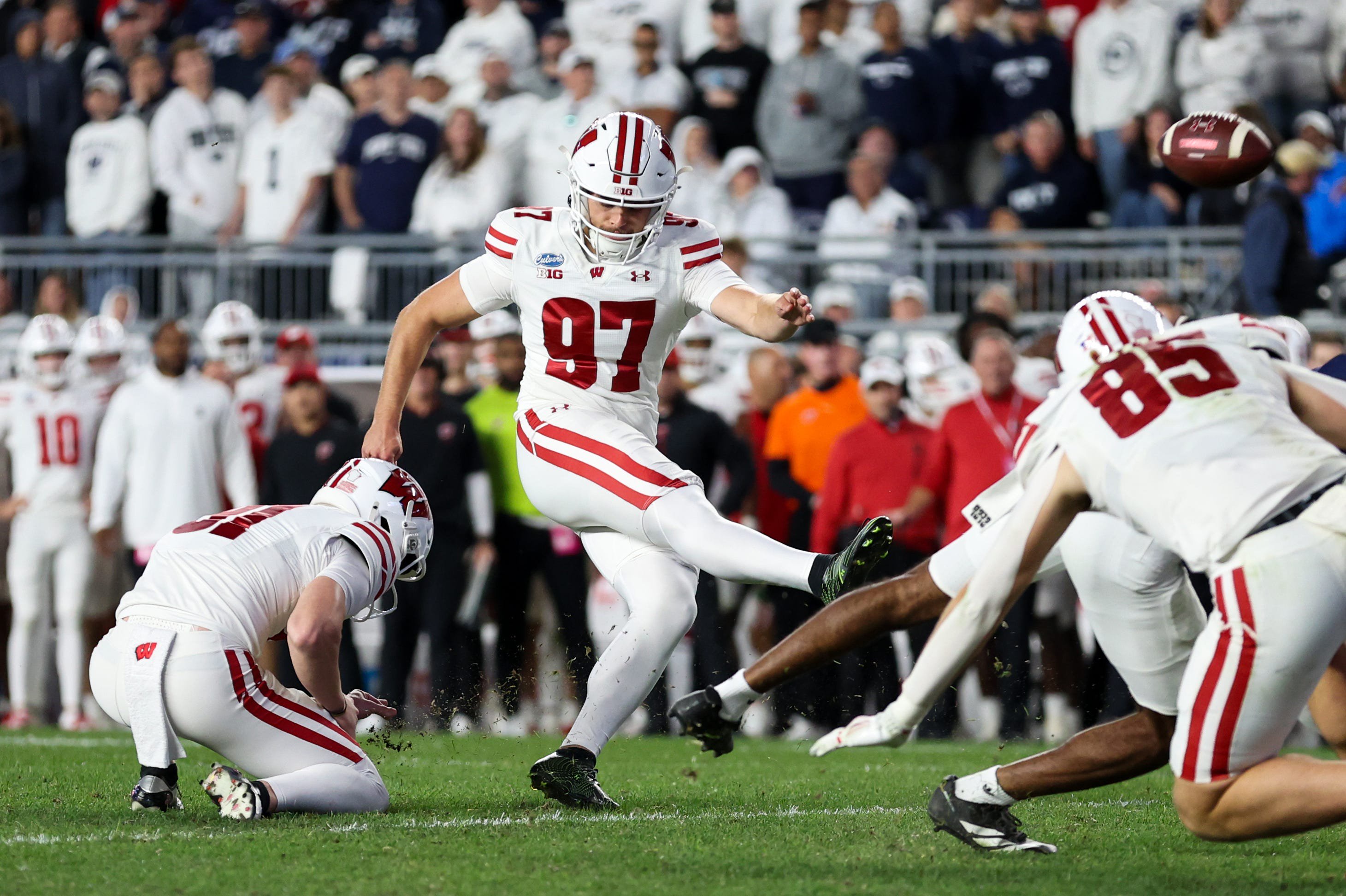 Sep 26, 2026; University Park, Pennsylvania, USA;  Wisconsin Badgers kicker Gavin Lahm (97) kicks the extra point during the fourth quarter against the Penn State Nittany Lions at West Shore Home Field at Beaver Stadium.  Mandatory Credit: Matthew O'Haren-Imagn Images