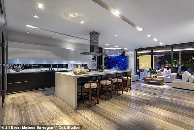 Inside, the tri-level property features expansive living and dining areas, rich hardwood and marble floors, custom cabinetry and a chef’s kitchen equipped with high-end Wolf and Miele appliances