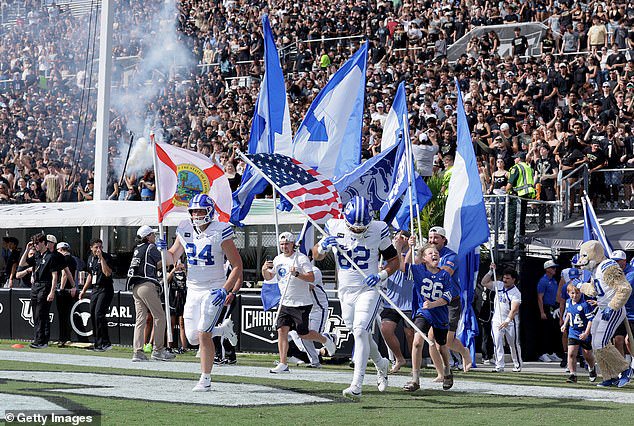 The BYU Cougars take the field before the game against the UCF Knights in Orlando