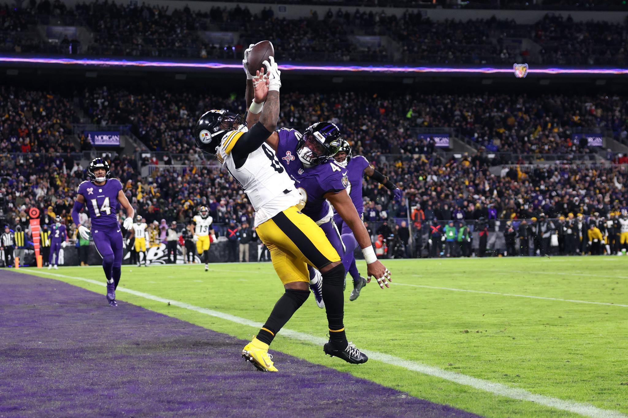 Cordarrelle Patterson #84 of the Pittsburgh Steelers catches a touchdown pass while defended by Malik Harrison #40 of the Baltimore Ravens during the third quarter at M&T Bank Stadium on December 21, 2024 in Baltimore, Maryland.  