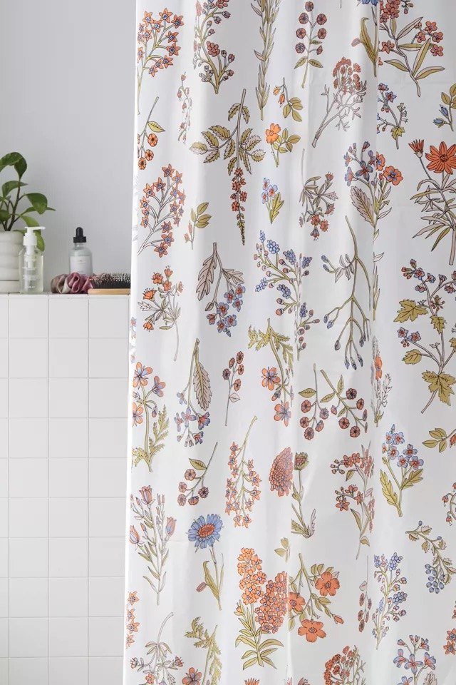 the shower curtain hanging in a bathroom