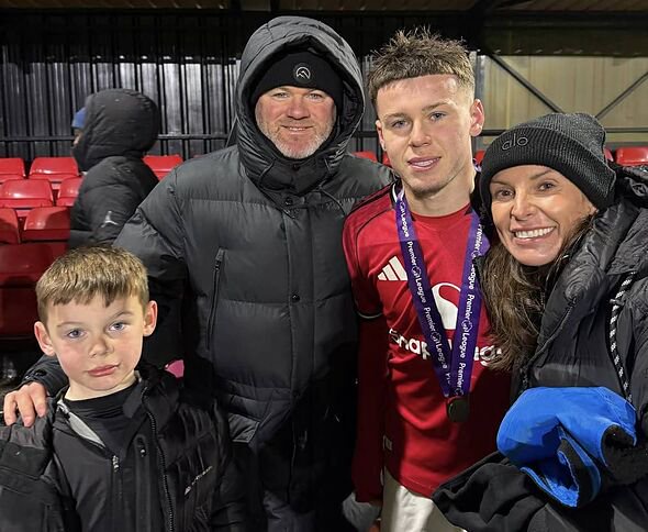 Kai Rooney with his parents after winning the Premier League Shield
